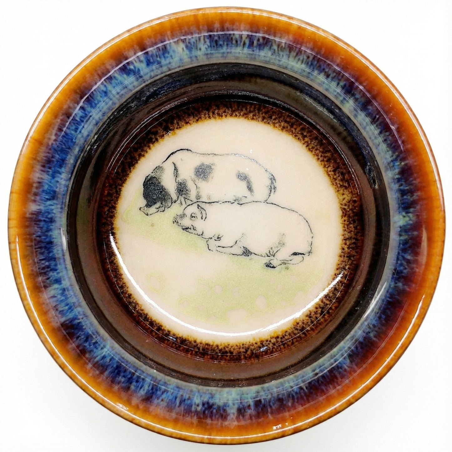Charming ceramic tea cup with a lucky Pig design, featuring smooth glaze and comfortable grip.