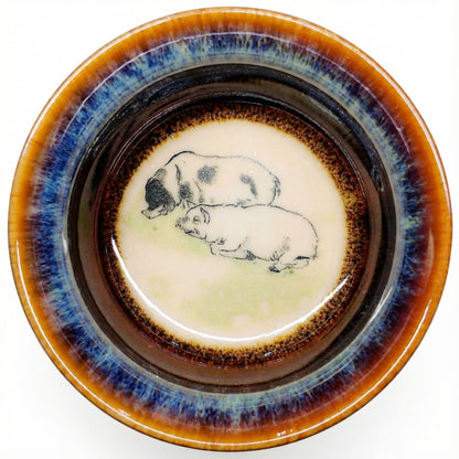 Charming ceramic tea cup with a lucky Pig design, featuring smooth glaze and comfortable grip.