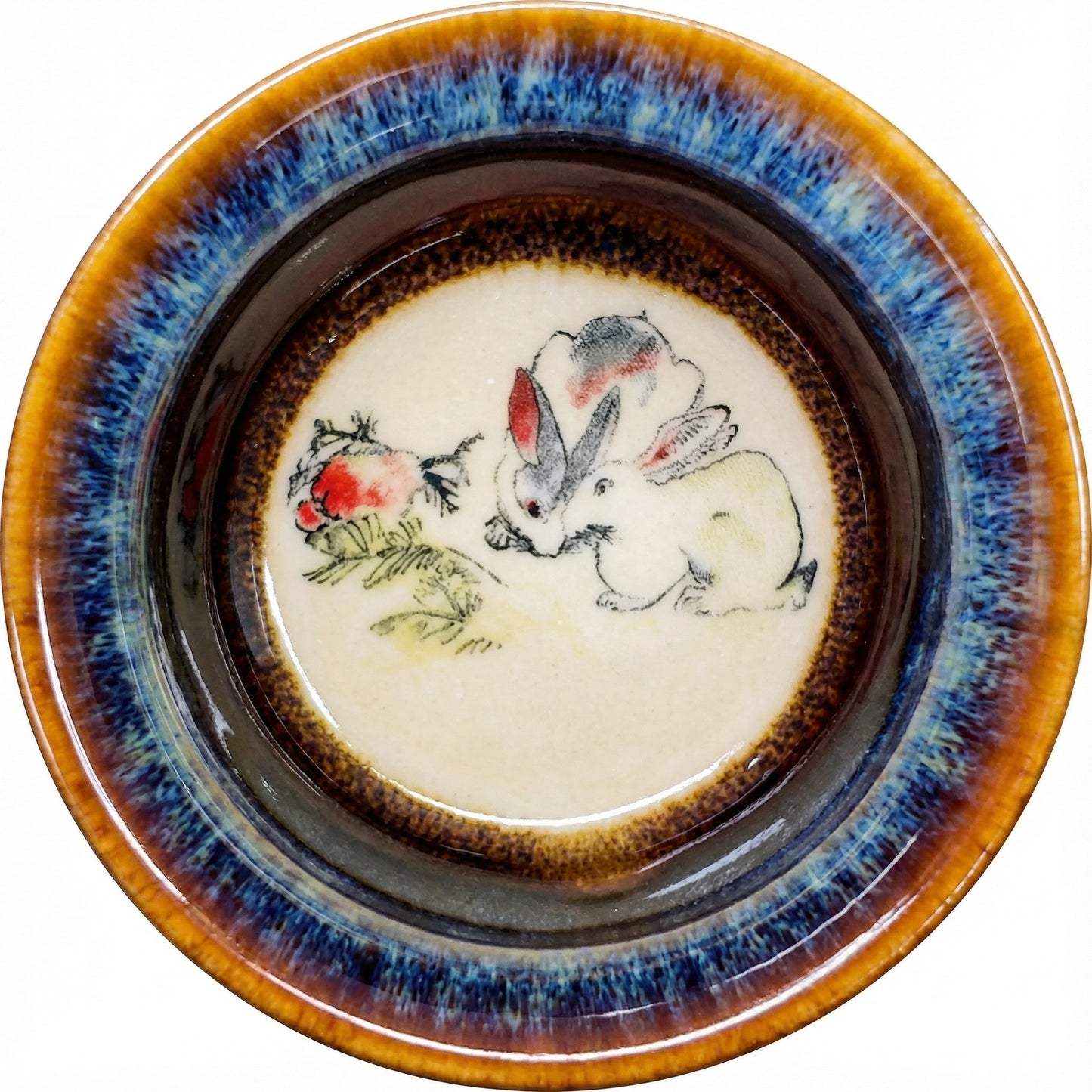 Delicate ceramic tea bowl with a gentle Rabbit design and artistic glaze texture.