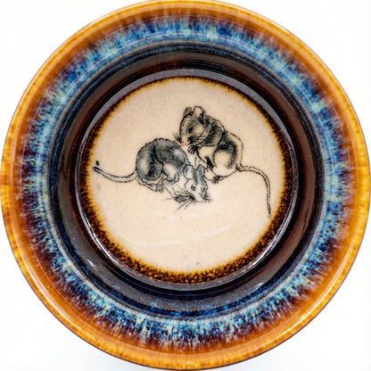 Handmade ceramic tea bowl featuring a clever Rat design inside with a unique kiln-glazed finish.