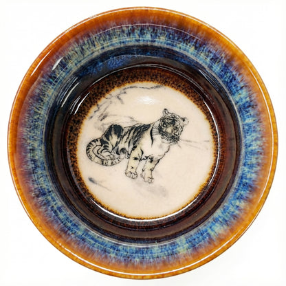 Ceramic tea cup featuring a fierce Tiger painting inside, perfect for Gongfu tea ceremony enthusiasts.